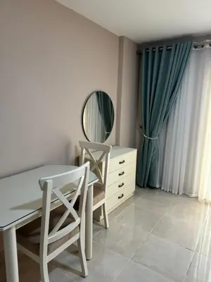 a room with a table and chairs and a mirror at Apartment with private beach 09D in Hurghada