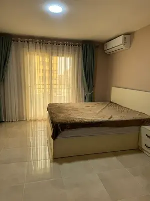 a bedroom with a large bed and a window at Apartment with private beach 09D in Hurghada