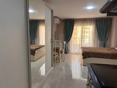 a room with a door leading to a bedroom at Apartment with private beach 09E in Hurghada