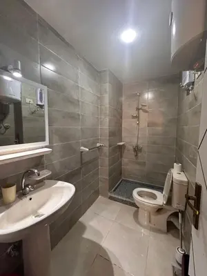 a bathroom with a sink and a toilet and a shower at Apartment with private beach 09E in Hurghada