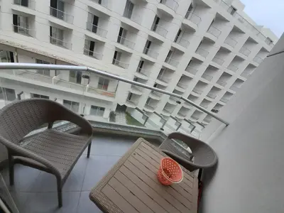 a balcony with a table and chairs and a building at شالية في كمباوند سكانديك عرابيا in Hurghada