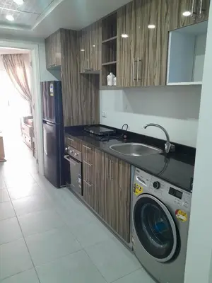 a kitchen with a washing machine and a sink at شالية في كمباوند سكانديك عرابيا in Hurghada