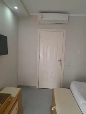 a bedroom with a white door and a bed at شالية في كمباوند سكانديك عرابيا in Hurghada