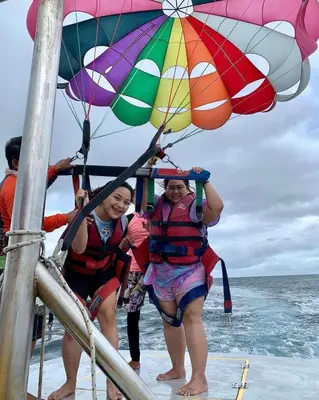 two women are standing under an umbrella on a boat at Marina Bay Elegance Room Balcony Overlooking Luxury Yachts in Hurghada