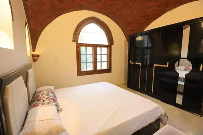 a bedroom with a large bed and a window at Desert Rose apartments in Luxor