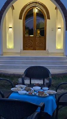 a table with plates of food in front of a building at Desert Rose apartments in Luxor