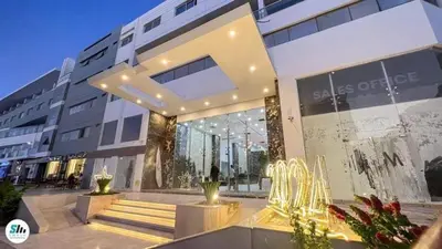 a large building with a staircase in front of it at شالية منتجع سكانديك عرابيا in Hurghada
