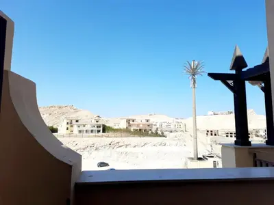 a view of the desert from a building with a palm tree at Units for rent in Hurghada in Hurghada