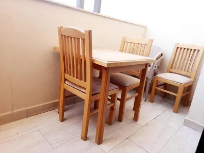 a wooden table and two chairs sitting next to a table at Units for rent in Hurghada in Hurghada