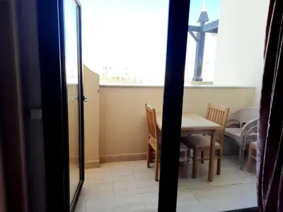 a room with a table and chairs and a window at Units for rent in Hurghada in Hurghada