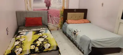 a bedroom with two beds with pandas on the sheets at Souzan house in Luxor