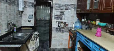 a small kitchen with a sink and a shower at Souzan house in Luxor