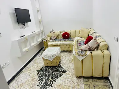 a living room with a couch and a tv at apartment in Hurghada