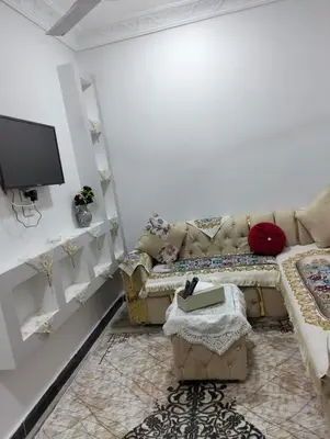 a living room with a couch and a tv at apartment in Hurghada