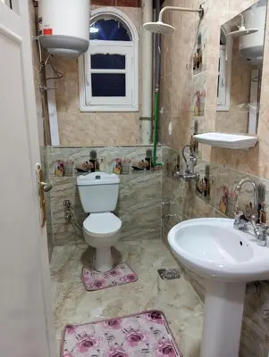 a bathroom with a toilet and a sink at apartment in Hurghada