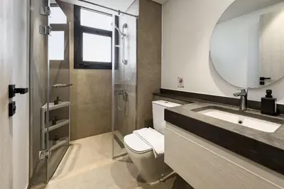 a bathroom with a toilet and a sink and a mirror at Cool & Curated 1BDR Kamaran El Gouna in Hurghada