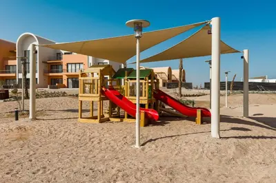 a playground on the beach with a canopy at Cool & Curated 1BDR Kamaran El Gouna in Hurghada