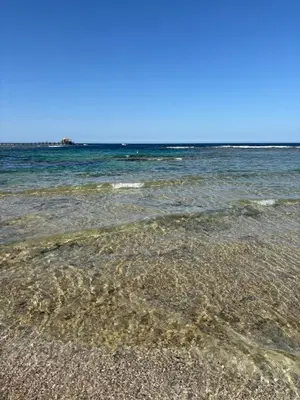 a sandy beach with the ocean in the background at DiveZen Sea View apartment in Quseir
