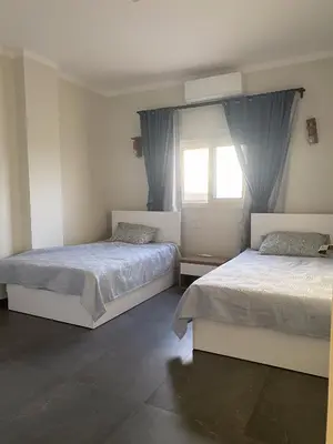 a bedroom with two beds and a window at DiveZen Sea View apartment in Quseir