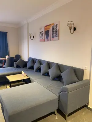 a living room with a couch and a table at DiveZen Sea View apartment in Quseir