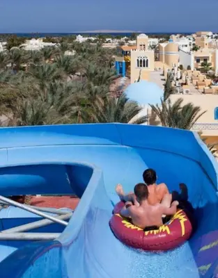 a couple of people riding on a water slide at a resort at Mirage Aqua Park Villa in Hurghada