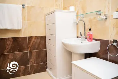 a bathroom with a sink and a white sink at Mirage Aqua Park Villa in Hurghada