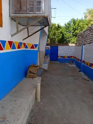 a building with a blue and white wall and a window at Nasser in Jazīrat Aswān
