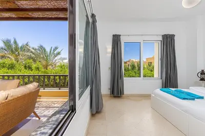 a living room with a bed and a balcony at Townhouse South Marina in Hurghada
