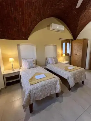 a bedroom with two beds in a room at Lady of the Sun Guesthouse in Luxor