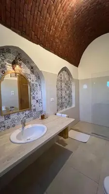 a bathroom with a sink and a mirror at Lady of the Sun Guesthouse in Luxor