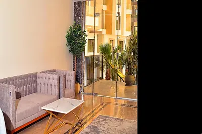 a living room with two couches and a table at One bedroom apartment with a hall in Aqua Infinity Resort before El Gouna in Hurghada