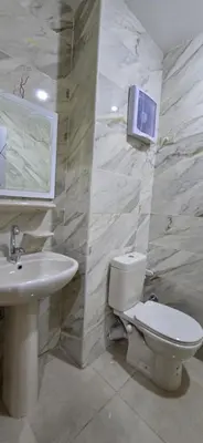 a bathroom with a toilet and a sink and a mirror at Tiba Golden Red Sea Coral Hurghada in Hurghada
