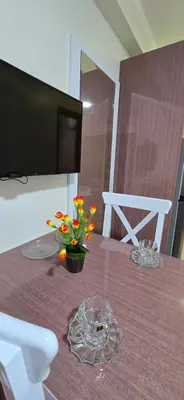 a table with a vase of flowers on top of it at Tiba Golden Sun-kissed Hurghada in Hurghada