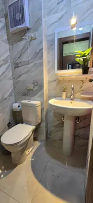 a bathroom with a toilet and a sink at Tiba Golden Sun-kissed Hurghada in Hurghada