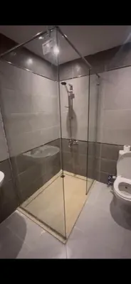 a glass shower in a bathroom with a toilet at Flat In Elhambra in Hurghada