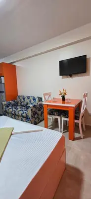 a hotel room with a table and a couch at Tiba Golden White Lagoon Hurghada in Hurghada