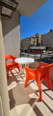 a table and two chairs on a balcony with a view at Tiba Golden White Lagoon Hurghada in Hurghada