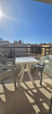 a white table and two chairs on a roof at Tiba Golden Royal Blue Hurghada in Hurghada