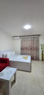 a room with a bed and a couch and a table at Tiba Golden Lagoon Hurghada in Hurghada