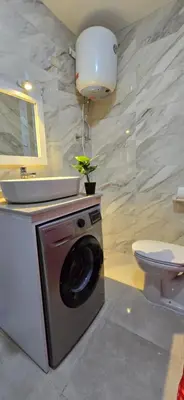 a bathroom with a washing machine and a sink at Tiba Golden Lagoon Hurghada in Hurghada