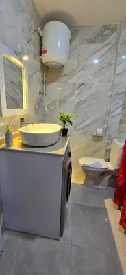 a bathroom with a sink and two toilets at Tiba Golden Lagoon Hurghada in Hurghada