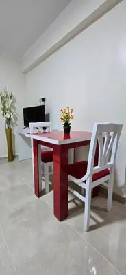 a red table and a chair with flowers on it at Tiba Golden Lagoon Hurghada in Hurghada