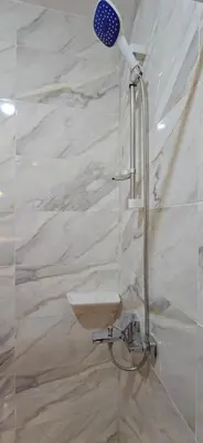 a shower with a shower head in a bathroom at Tiba Golden Lagoon Hurghada in Hurghada