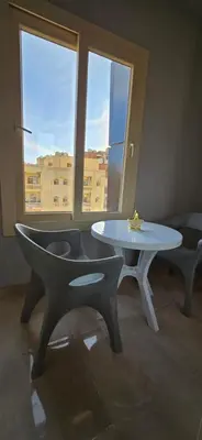 a table and chairs in a room with a window at Tiba Golden Private Beach Hurghada in Hurghada