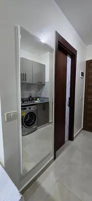 a kitchen with a stove and a glass door at Tiba Golden Private Beach Hurghada in Hurghada
