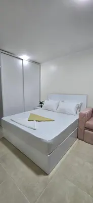 a large white bed in a white room at Tiba Golden Blue Oasis Hurghada in Hurghada