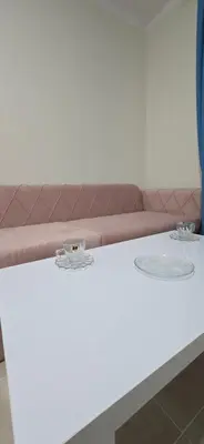 a white table with a couch in a room at Tiba Golden Blue Oasis Hurghada in Hurghada