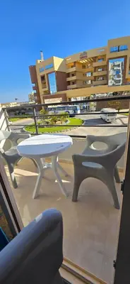 a table and two chairs on a balcony at Tiba Golden Blue Oasis Hurghada in Hurghada