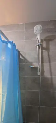 a shower in a bathroom with a blue shower curtain at Tiba Golden Blue Oasis Hurghada in Hurghada