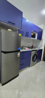 a kitchen with a refrigerator and a washing machine at Tiba Golden Blue Oasis Hurghada in Hurghada